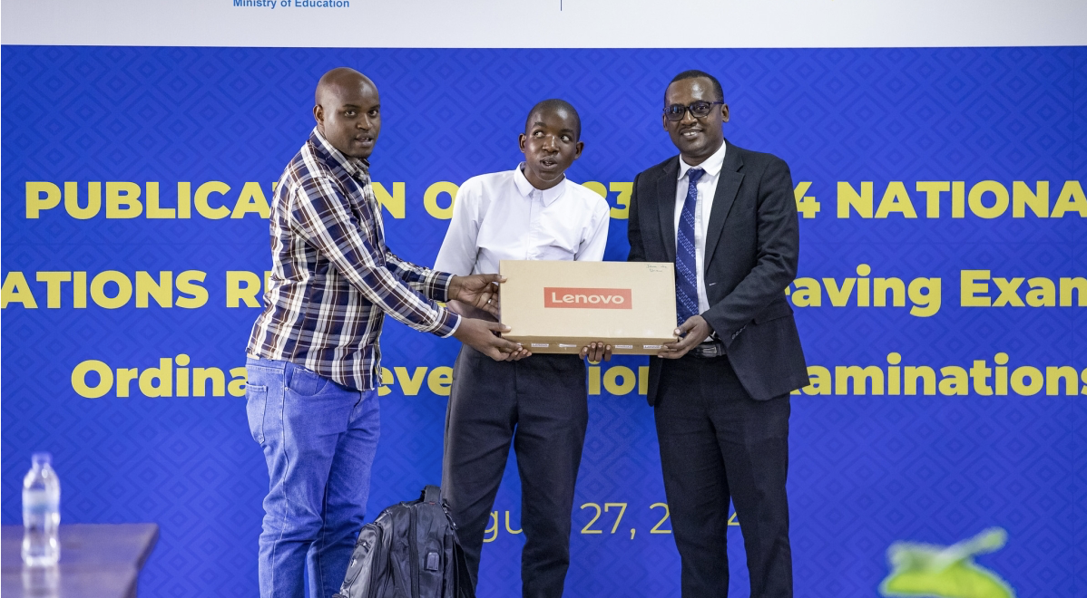 Jean de Dieu Niyonzima, one of best performers in O-Level national exams, receives a Lenovo laptop during the release of the results on Monday, August 27.