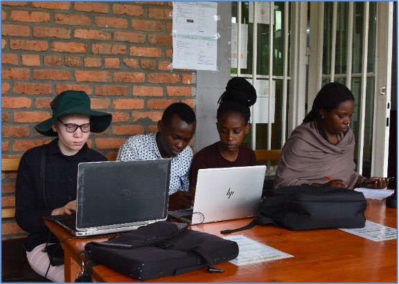 Ms. Bertine Iradukunda (left with glasses) doing group work with her classmates (photo/Vedaste)