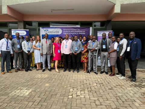 Group photo of ANSWER partners in front of ANSWER banner